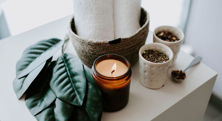 candle with towels, leaves & tea